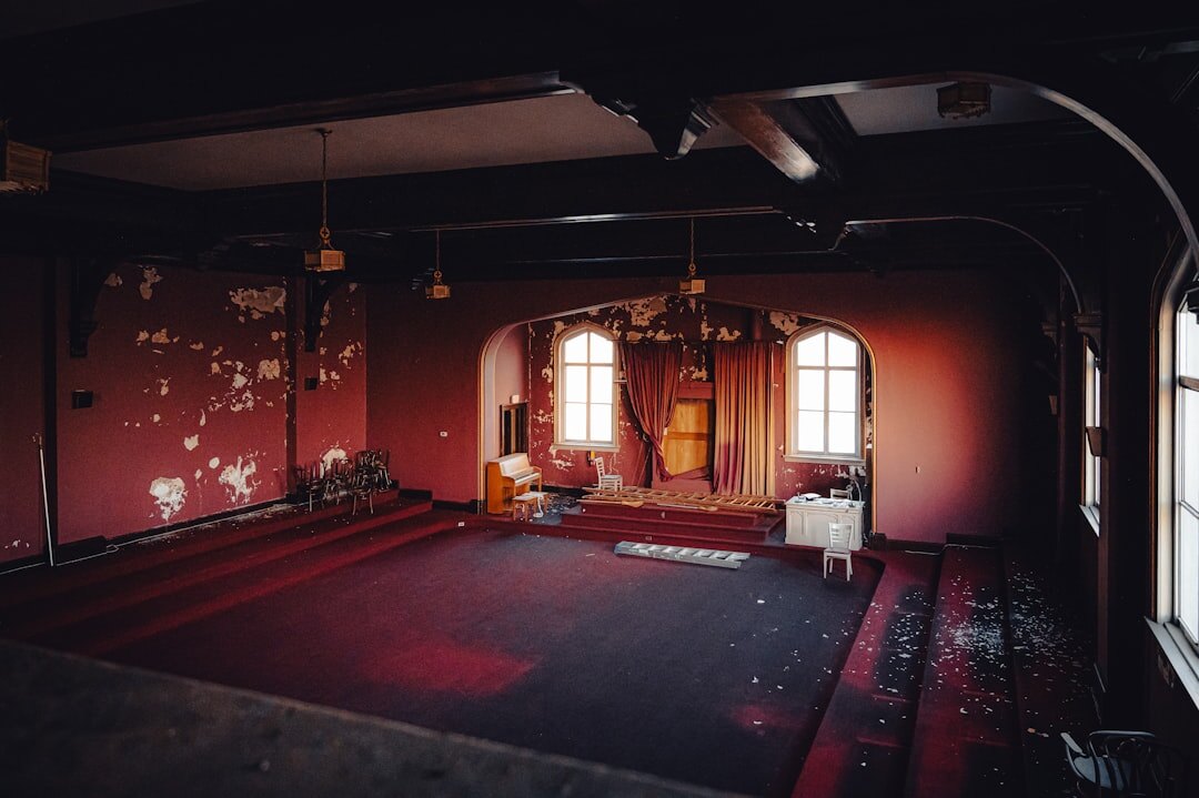 Ornate vintage theater interior with red velvet seats