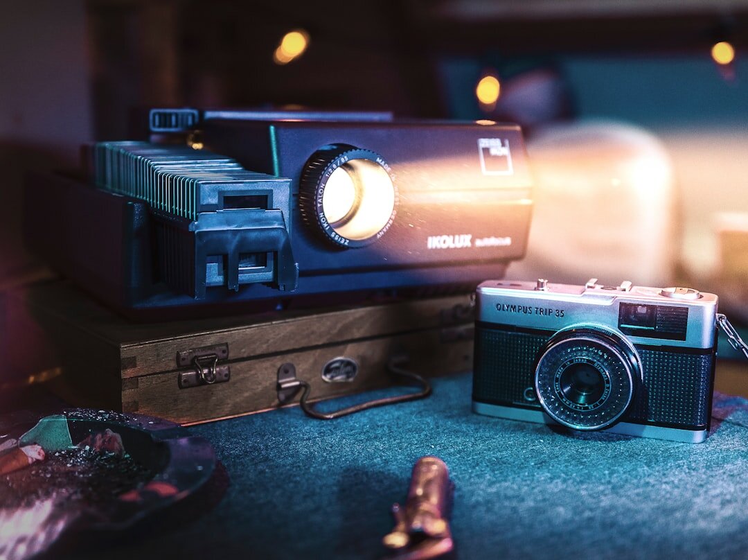 Vintage film reel and cinema projector in warm light